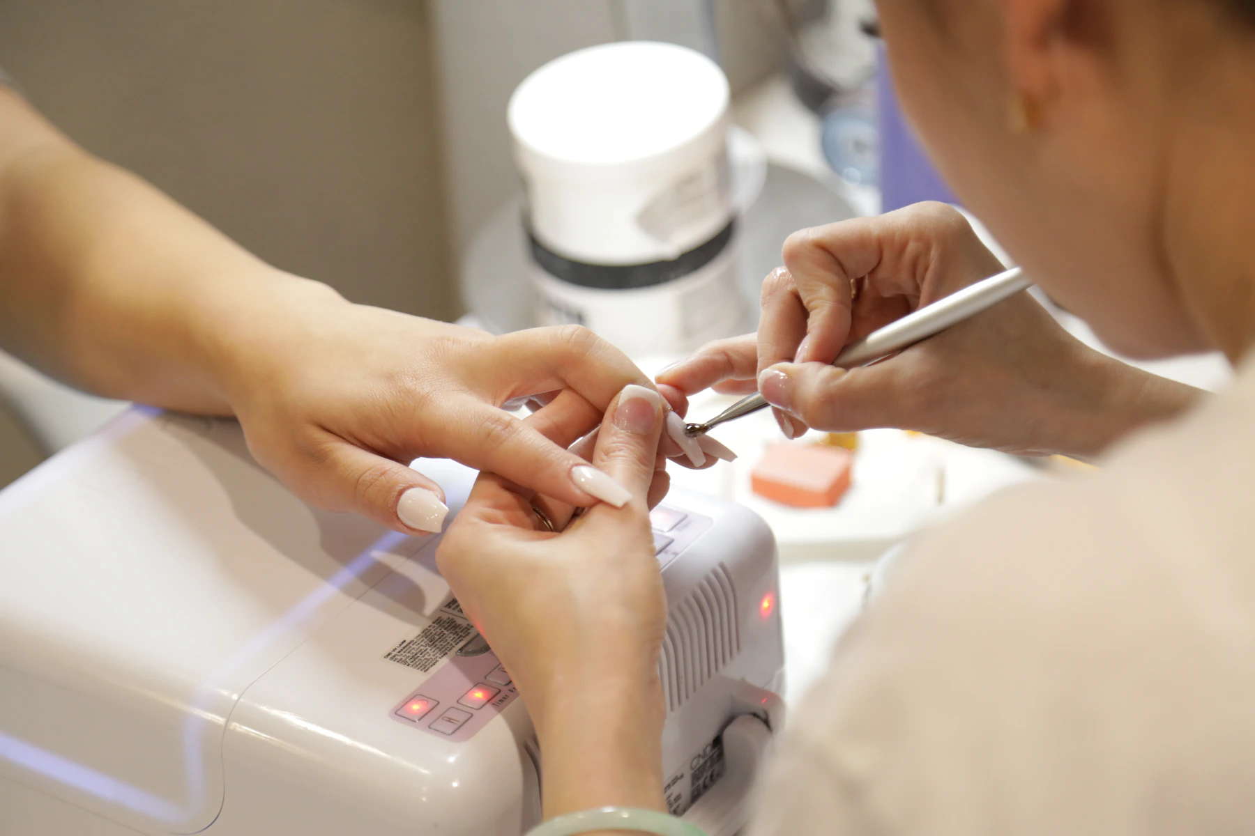 Nail technician giving a client a manicure